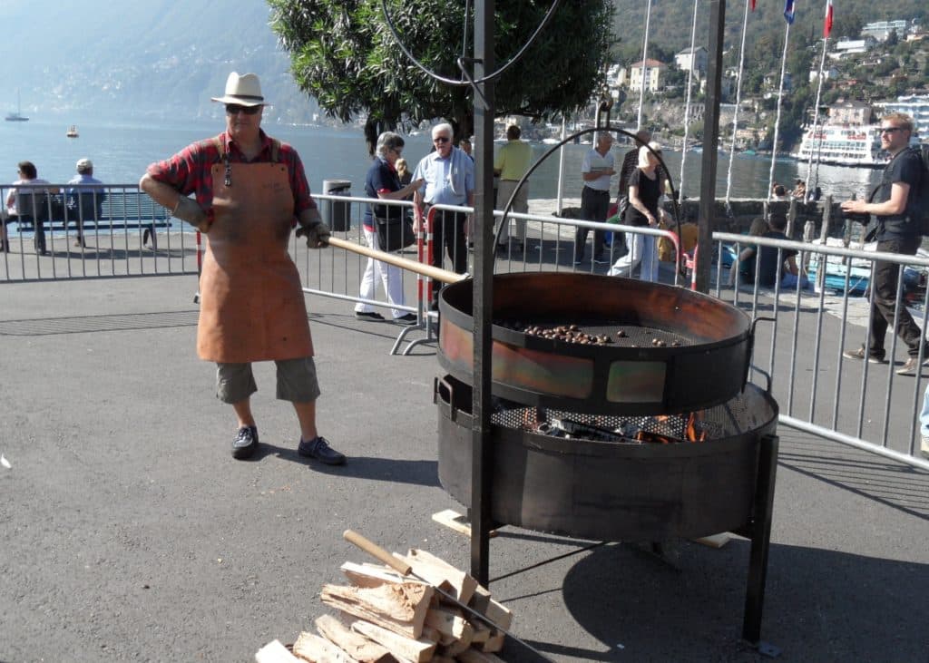 Chestnut roaster at the Chestnut Festival at Lake Maggiore during a luxury Swiss adventure.