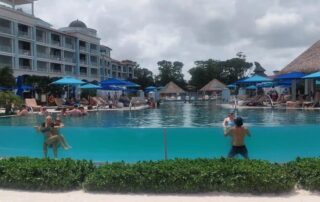 Couples enjoying the infinity pool at Sandals Royal Barbados.