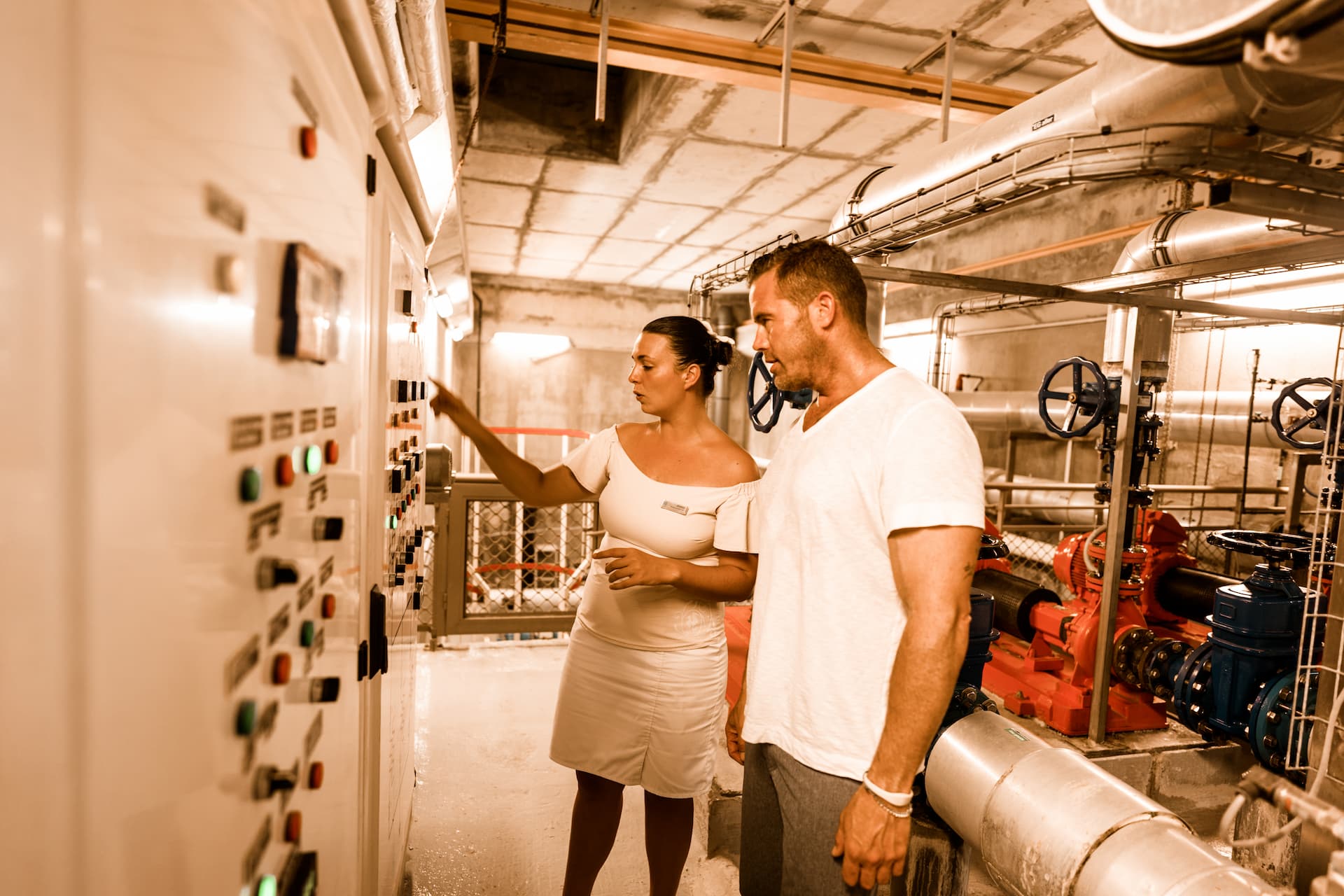 A couple learning about the sea water air conditioning system during the green tour at The Brando resort.