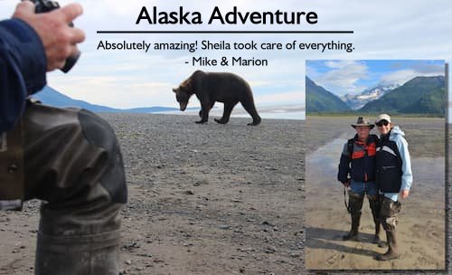 Couple on a beach in Homer, Alaska, with a bear in the background during their stress-free Alaska adventure planned by Sheila.