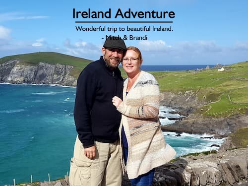 A couple standing on an outcropping with the Cliffs of Moher in the background during their wonderful trip to Ireland planned by Sheila Cannon.