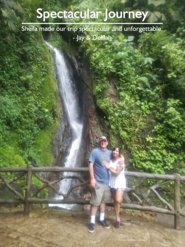 Couple in front of a waterfall with lush foliage in Costa Rica, enjoying their unforgettable trip planned by a Costa Rica honeymoon planner.