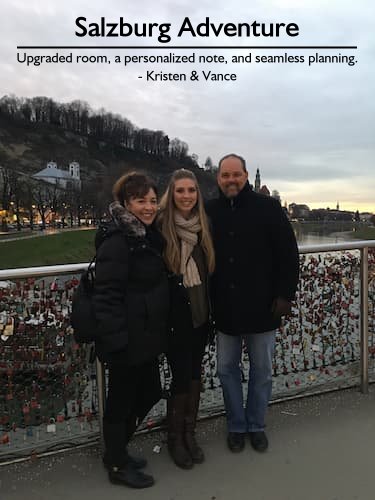 Family of three standing on the Love Locks Footbridge in Salzburg, Austria during their vacation, expertly planned by Sheila Cannon.