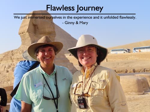 Two women in safari clothes smiling in front of The Great Sphinx of Giza during their perfect Egyptian adventure, planned flawlessly by Sheila Cannon.