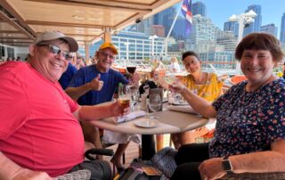 Lucia, Doug, Ric, and Kim enjoying lunch on the Oceania Regatta with Seattle in the background.