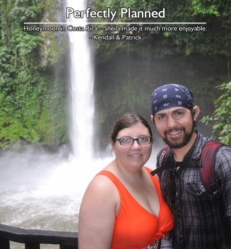 Couple standing in front of a waterfall during their Costa Rica honeymoon in Arenal, Tamarindo, and San Jose, perfectly planned by Sheila.