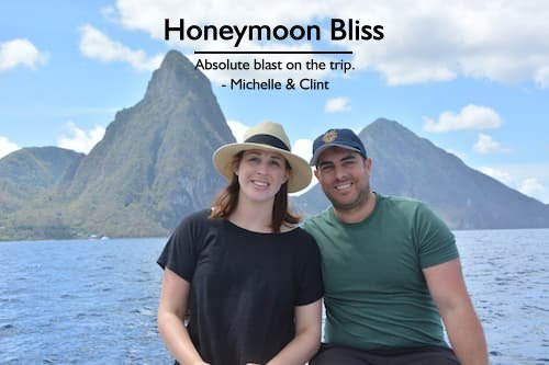 Sandals honeymoon in St. Lucia planned by Sheila | Couple in boat with St. Lucia Pitons