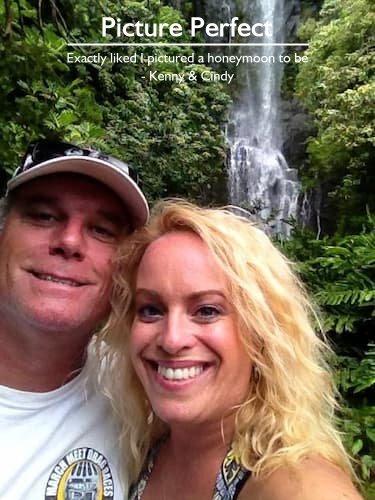 Kenny & Cindy standing by a lush waterfall on their honeymoon in Maui, planned by Sheila from Carefree Romantic Vacations.