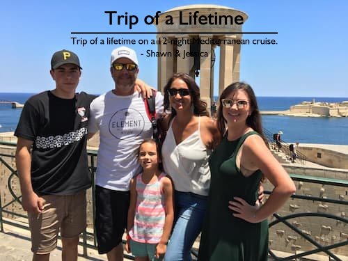 Beautiful family of five smiling in front of a European monument with the ocean as a backdrop during their Mediterranean family cruise, planned by Sheila at Carefree Romantic Vacations.