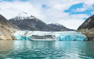 Oceania Regatta ship floating in front of the magnificent Hubbard Glacier during an Alaska cruise adventure.