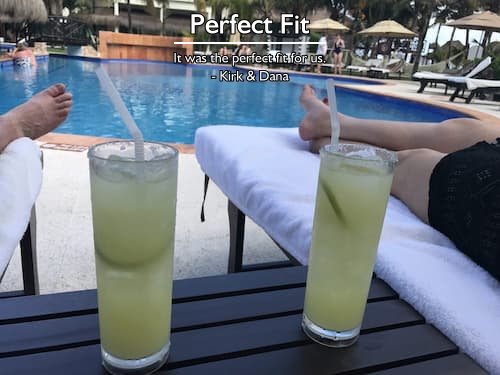 Couple relaxing by the pool with margaritas at a luxurious resort, romantic anniversary trip planning by Sheila at Carefree Romantic Vacations.