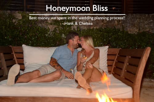 Couple relaxing at their resort in Jamaica, enjoying a stress-free honeymoon planned by Sheila with a romantic fire pit and a glass of wine.