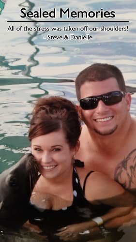 Steve and Danielle enjoying their belated Bahamas honeymoon cruise with a seal kissing Danielle, planned by Carefree Romantic Vacations.