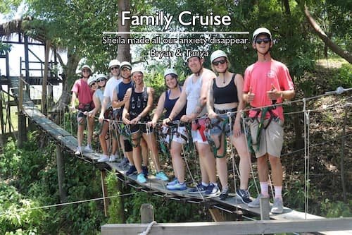 A smiling family of 10 on a suspension bridge during their stress-free family cruise excursion, planned by Sheila Cannon.