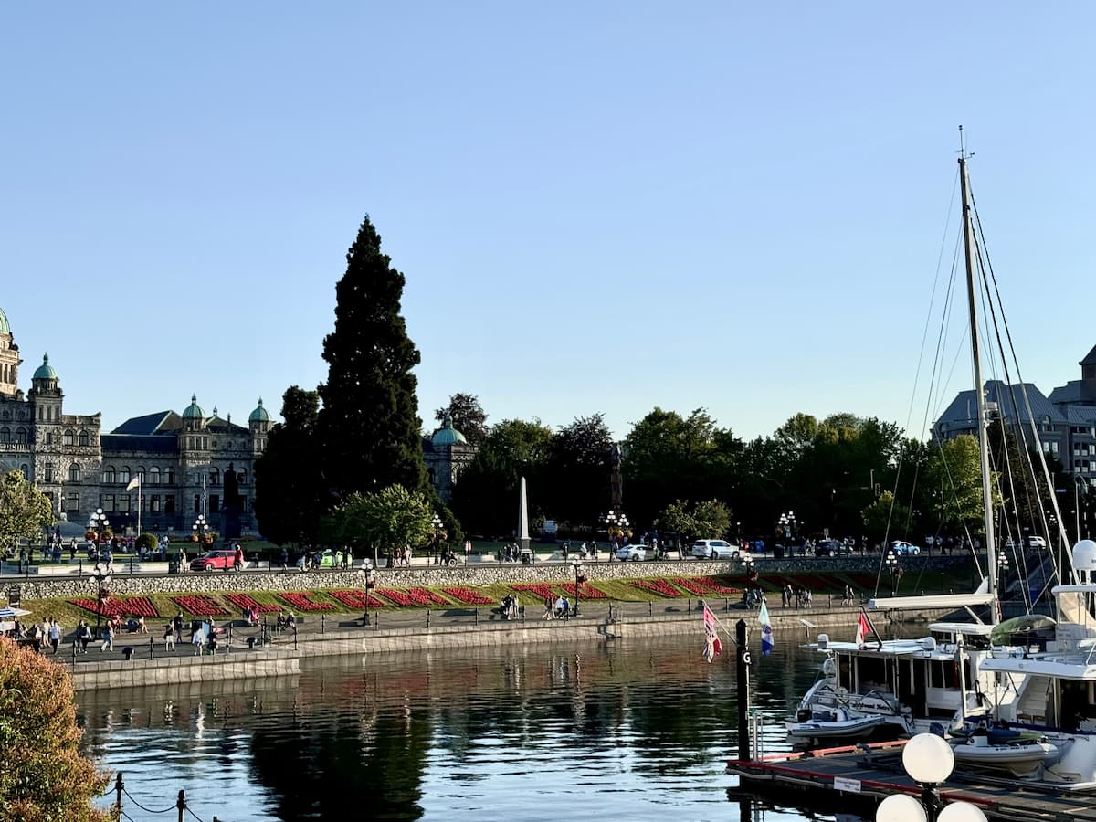 Victoria waterfront with "Welcome to Victoria" in red flowers and the Empress Hotel in the background, a scenic stop on a 10-day Alaska cruise adventure.